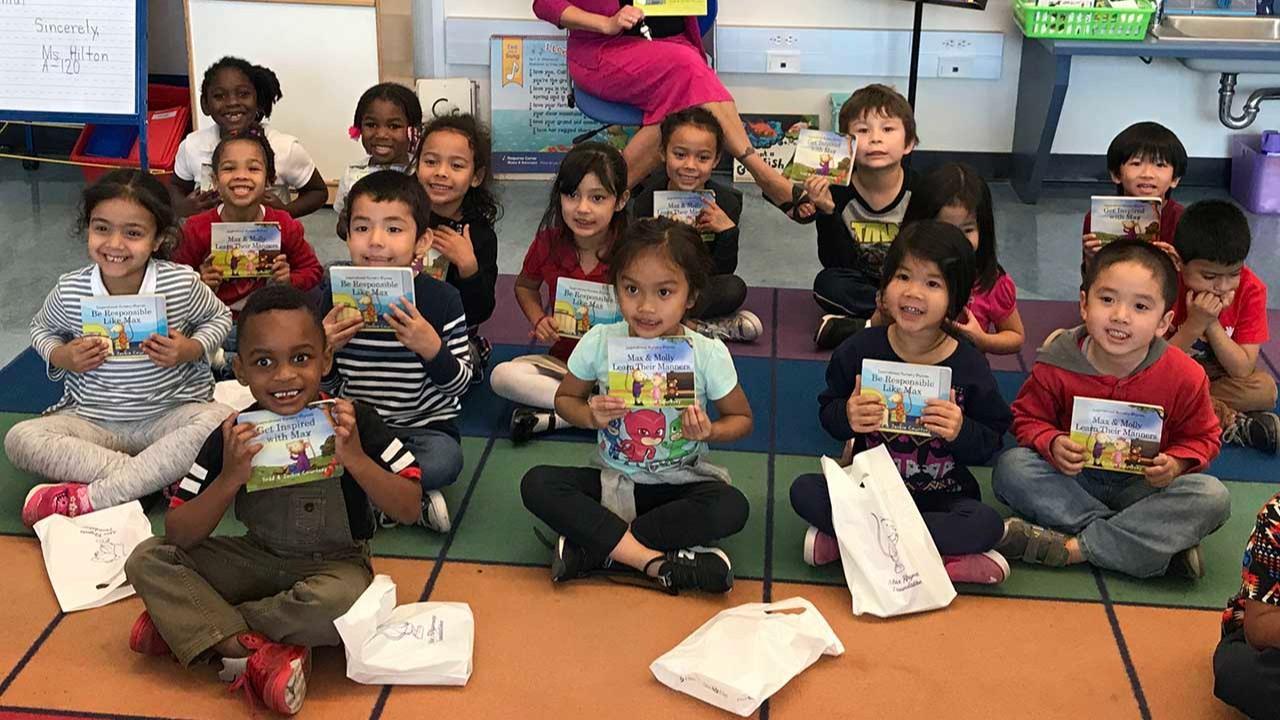 Classroom of students holding Max Rhymes® books, learning reading skills, positive behavior, core values, self-respect, respect for others